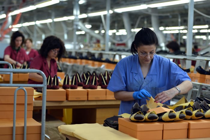 Workers shown at the Le Marche factory of Italian shoes and luxury leather goods Tod's, which makes 2.5 million pairs of shoes each year in its Italian workshops.