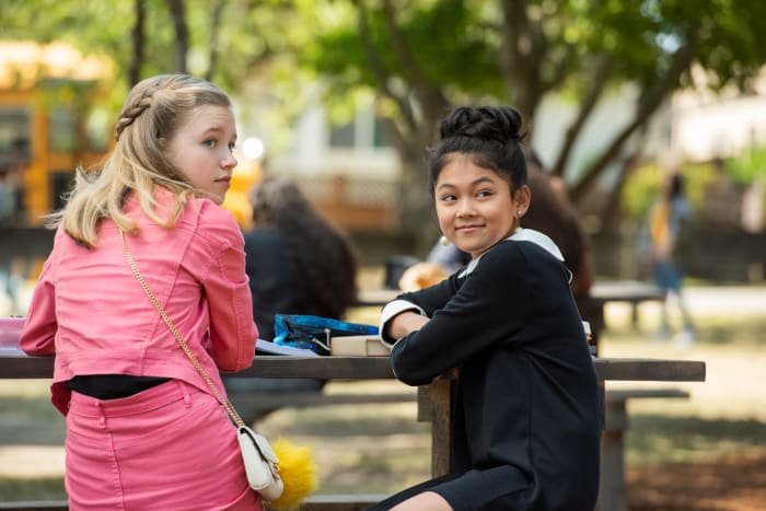 "I wore a special smart outfit. Ruth Bader Ginsberg chic. Super cute." Tamada as Claudia, right, sits with real life friend Shay Rudolph as Stacey.