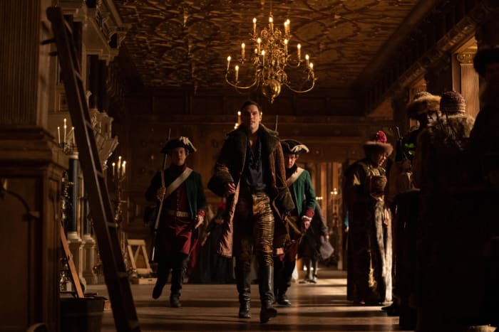 Peter (Nicholas Hoult, second from left) fights his wife's coup in a faux leopard coat and yellow denim pants.