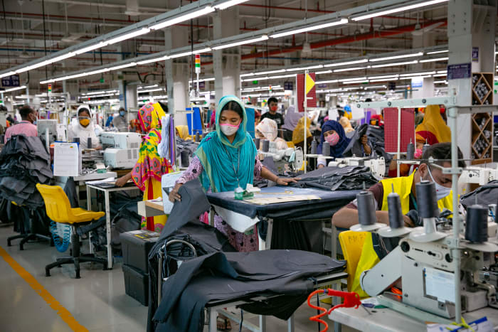 Garment workers work at a factory during a countrywide lockdown to try to contain the spread of Covid-19 on July 5, 2021 in Dhaka, Bangladesh