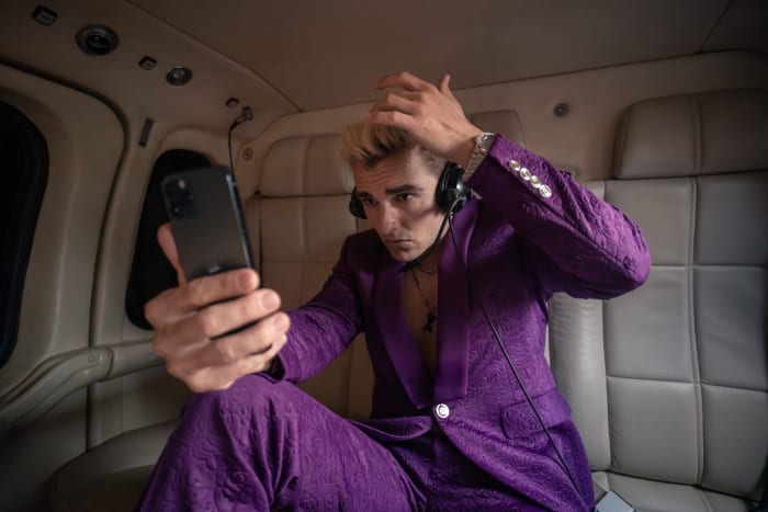 Xavier does a quick hair check after jumping into the helicopter he took to the reunion.
