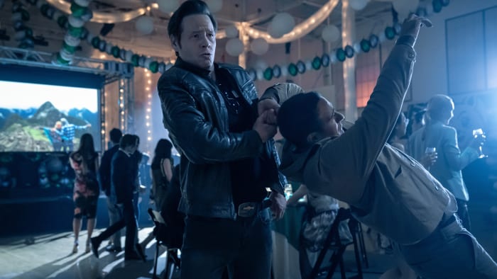Brett (Ike Barinholtz) finally notices Walt (Jamie Demetriou) as he makes his way, fast and furious, into the reunion.
