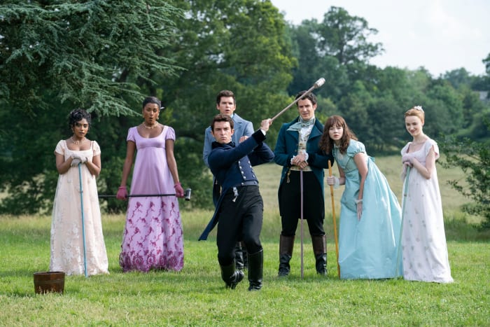 Edwina Sharma (Charithra Chandran) and sister Kate (Simone Ashley) play pall-mall with the Bridgertons: Anthony (Jonathan Bailey), Colin (Luke Newton), Benedict (Luke Thompson), Eloise (Claudia Jessie) and Daphne (Phoebe Dynevor).