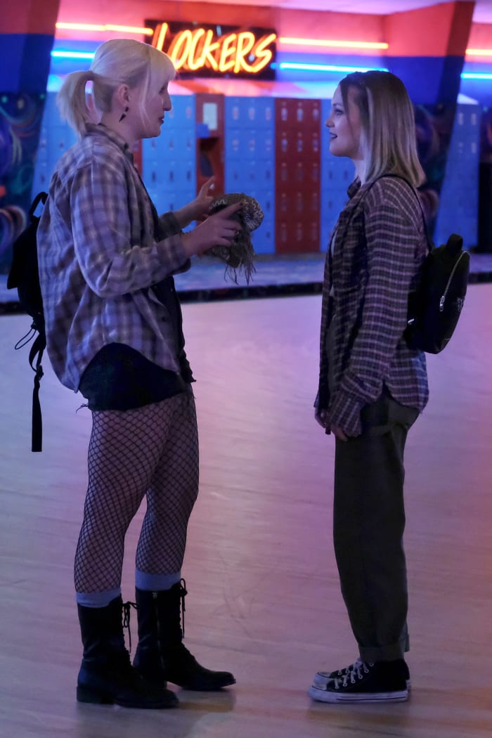 A Mallory and Kate (Olivia Holt) in quintessential '90s grunge at the skating rink.