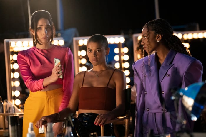 Luna Lu (Zion Moreno), left, wearing a Cinq à Sept top, with Julien Calloway (Jordan Alexander), center, and Monet de Haan (Savannah Lee Smith).