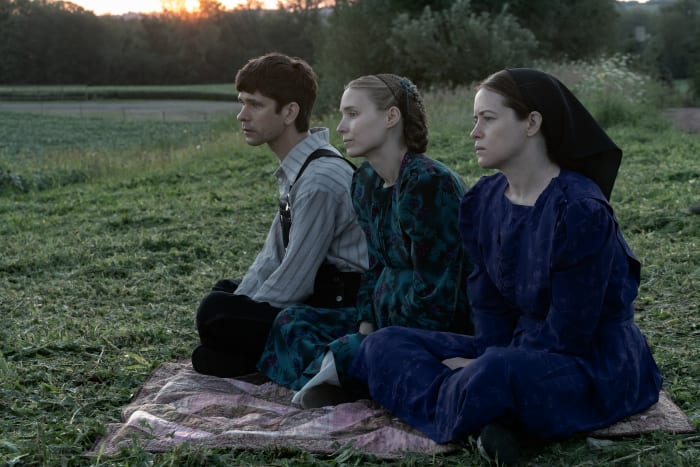 Augustus (Ben Whishaw, left) documents the meeting, as the women are not allowed to learn to read or write.