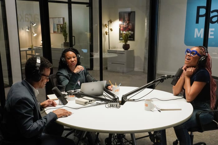 Phoebe's brother Jayden (Jordan Carlos), podcasting colleague/friend Malika and Phoebe chat in the studio.