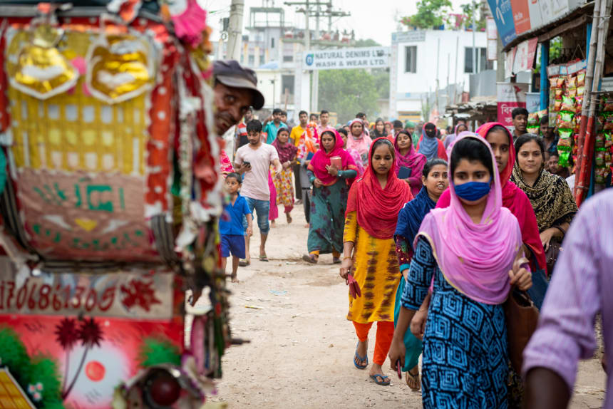 A sea of women leaving a garment factory after their shift ends at a denim factory.