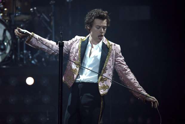 Harry Styles in a custom Gucci suit performing in London on Wednesday. Photo: Gareth Cattermole/Getty Images
