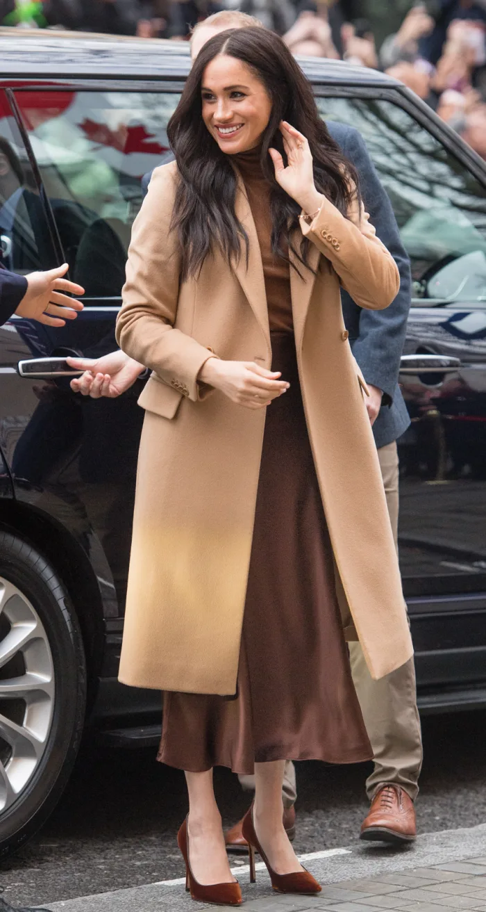 meghan-markle-style-fashion-vince-skirt-camel-coat.webp