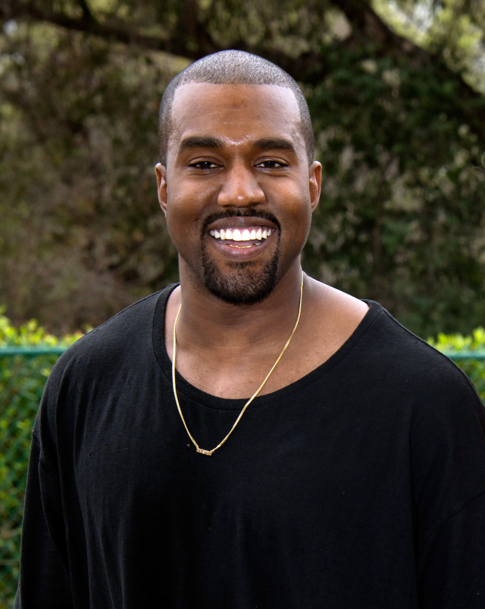 Kanye West, smiling! Photo: Amanda Edwards/Getty Images