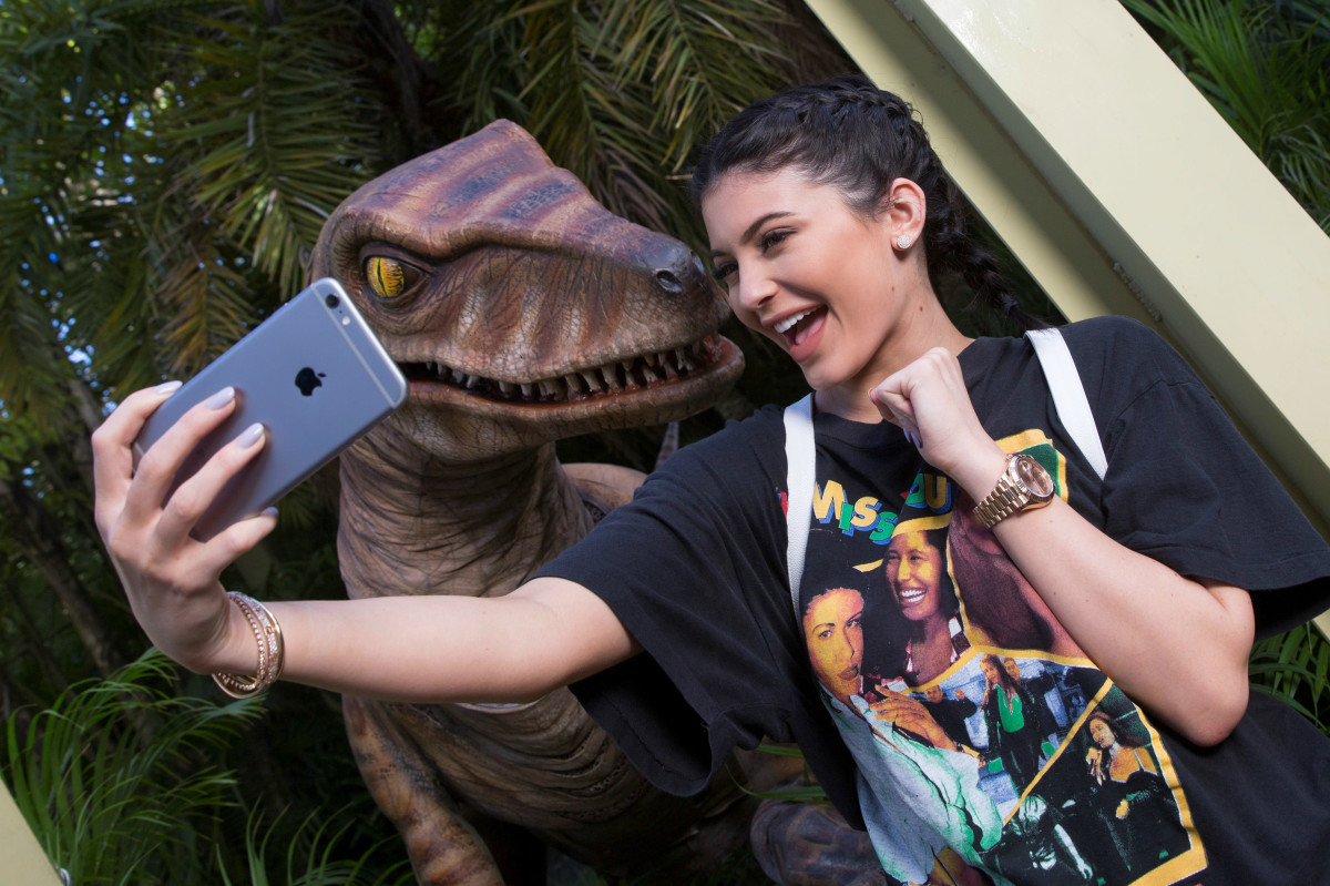 Kylie Jenner and a Velociraptor at Universal Orlando Resort on Wednesday. Photo: Universal Orlando via Getty Images