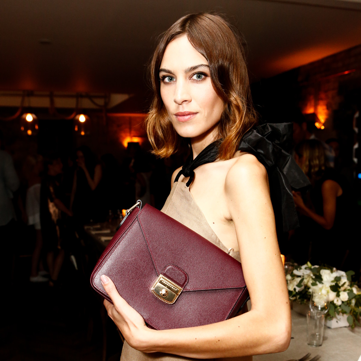 Alexa Chung showing off a new clutch at the Longchamp dinner Tuesday night. Photo: Longchamp