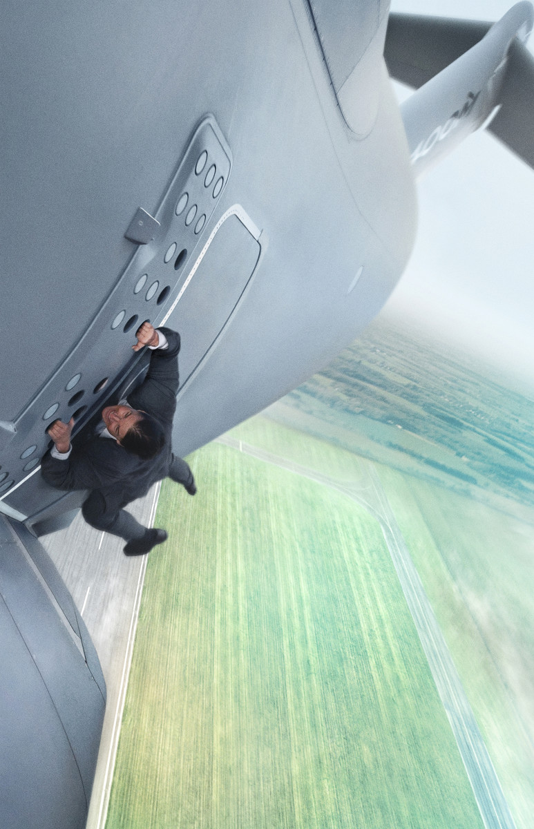 Tom Cruise hanging off an airplane in a bespoke suit. As one does. Photo: Bo Bridges/Paramount Pictures