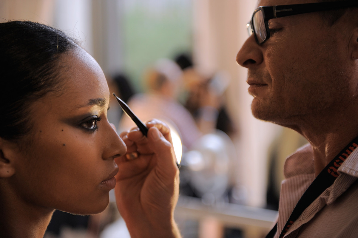 Makeup artist Tom Pecheux plies his craft. Photo: Jemal Countess/Getty Images. 