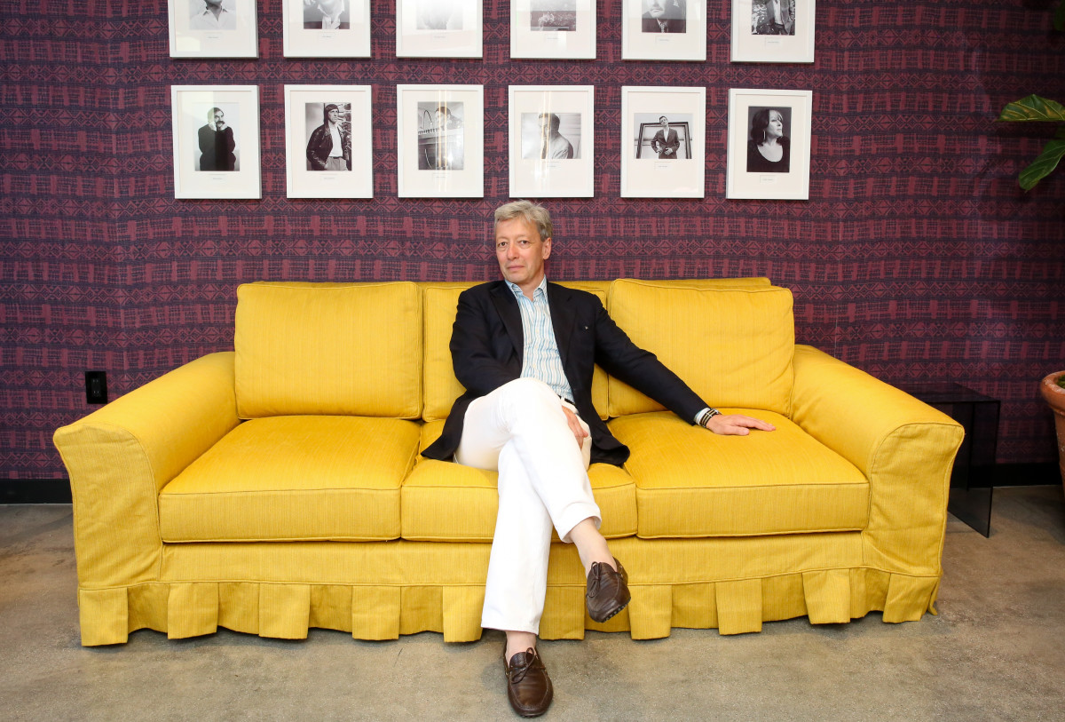 Frederic Malle sits beneath portraits of his perfumers at his new Los Angeles store. Photo: Marc Patrick for BFA.com