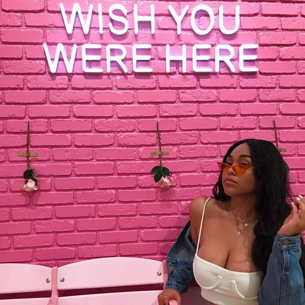 Jordyn Woods in Poppy Lissiman sunglasses and an Orseund Iris top. Photo: Instagram/@poppylissiman