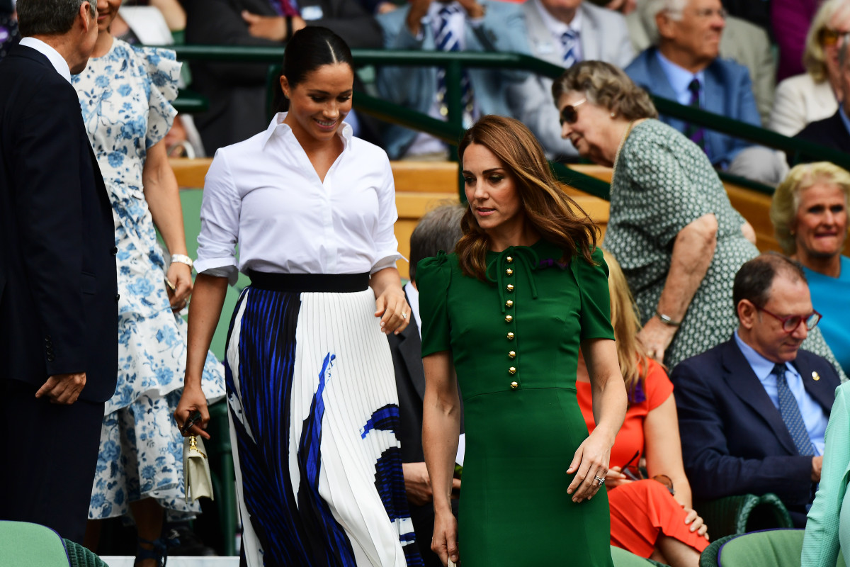 Meghan Markle, Duchess of Sussex, in a Hugo Boss skirt and Kate Middleton, Duchess of Cambridge, in a Dolce & Gabbana Dress at the Wimbledon women's singles final in London, England. Photo: Shaun Botterill/Getty Images
