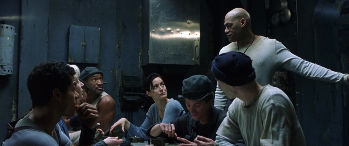 Tank (Marcus Chong), Switch (Belinda McCrory), Dozer (Anthony Ray Parker), Trinity, Mouse (Matt Doran), Morpheus (standing, Laurence Fishburne) and Neo in reality aboard the Nebuchadnezzar hovercraft. The movie featured color codes: blue in reality and green in The Matrix (above). Photo: Screengrab/The Matrix
