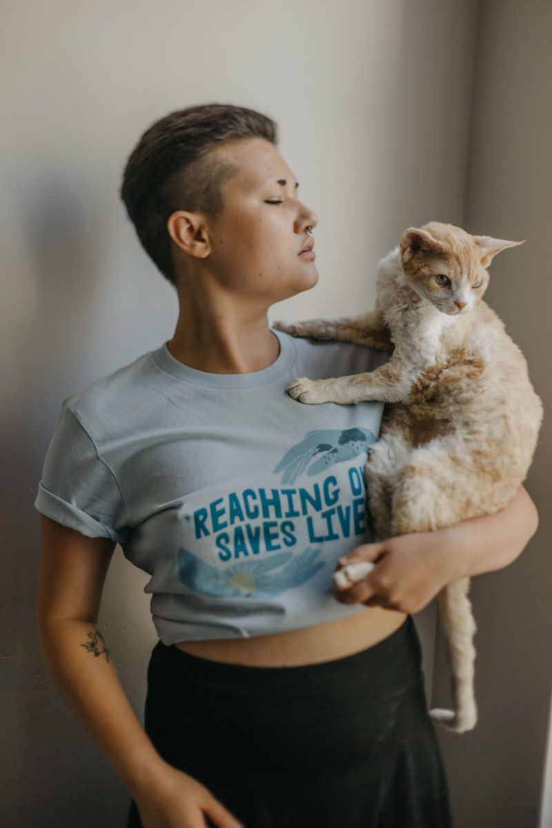 Self-Care Is for Everyone's "Reaching Out Saves Lives" T-shirt, supporting the National Suicide Prevention Lifeline.
