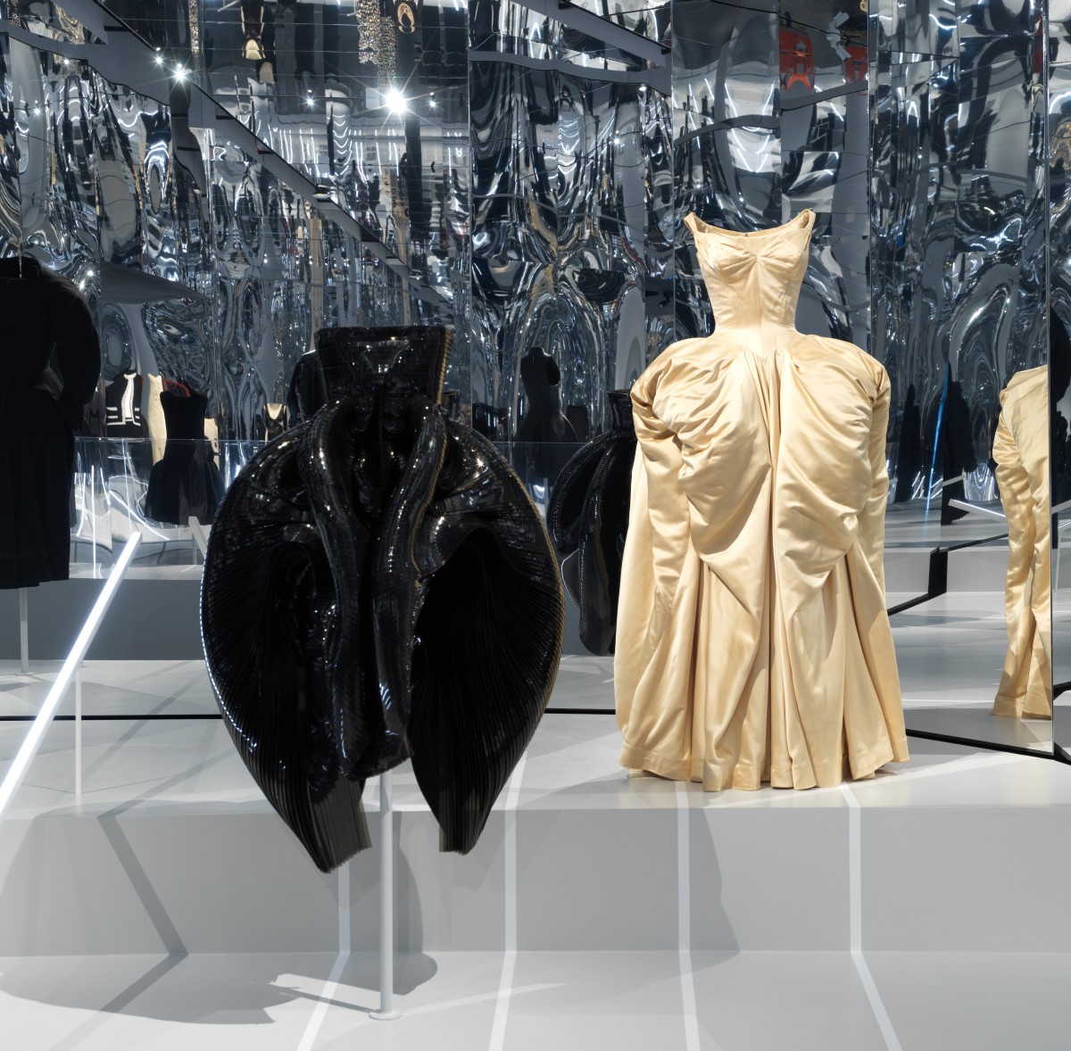 An Iris Van Herpen gown from Fall 2012, left, and a Charles James gown from 1951, right.