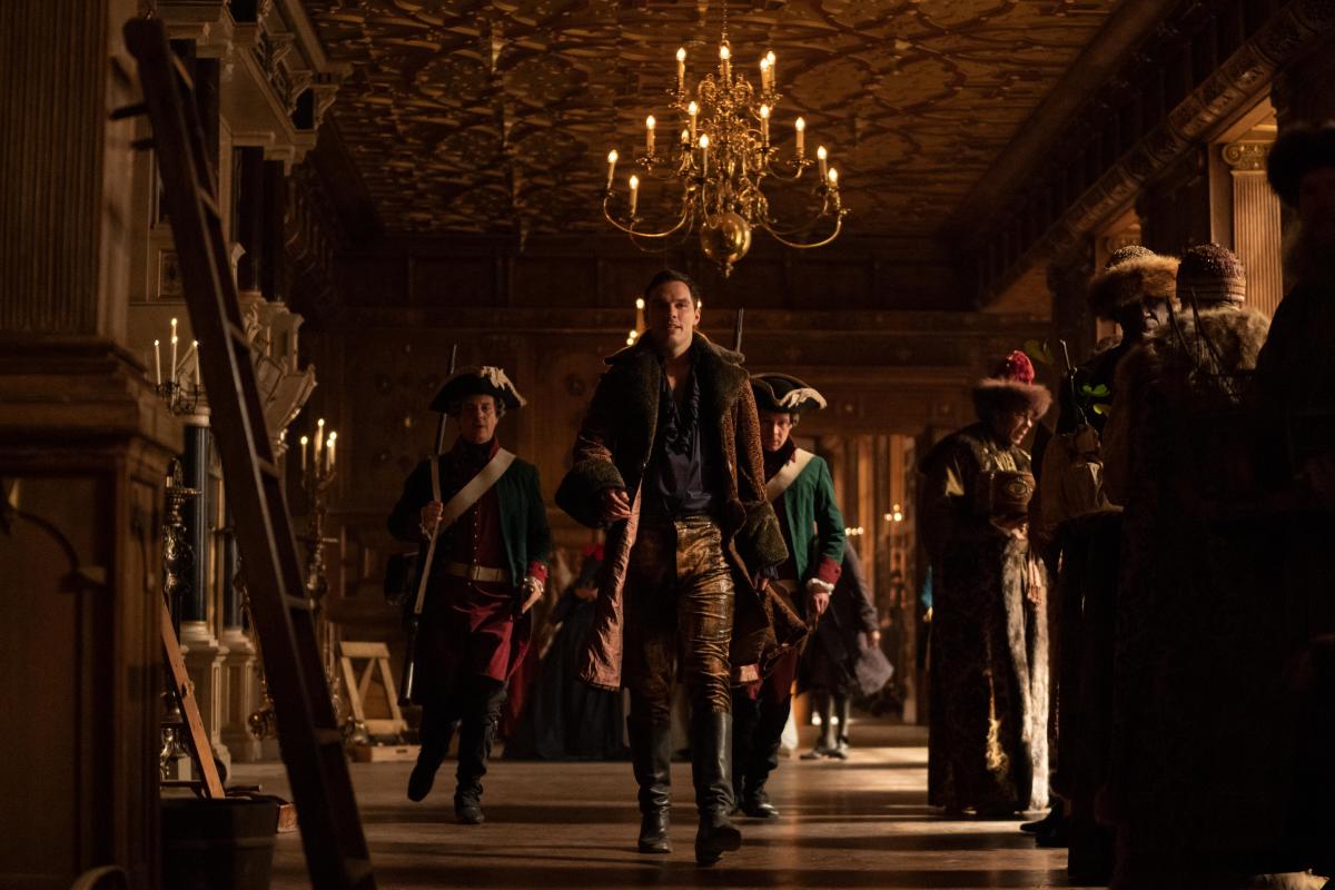Peter (Nicholas Hoult, second from left) fights his wife's coup in a leopard print faux fur jacket and gold denim pants.