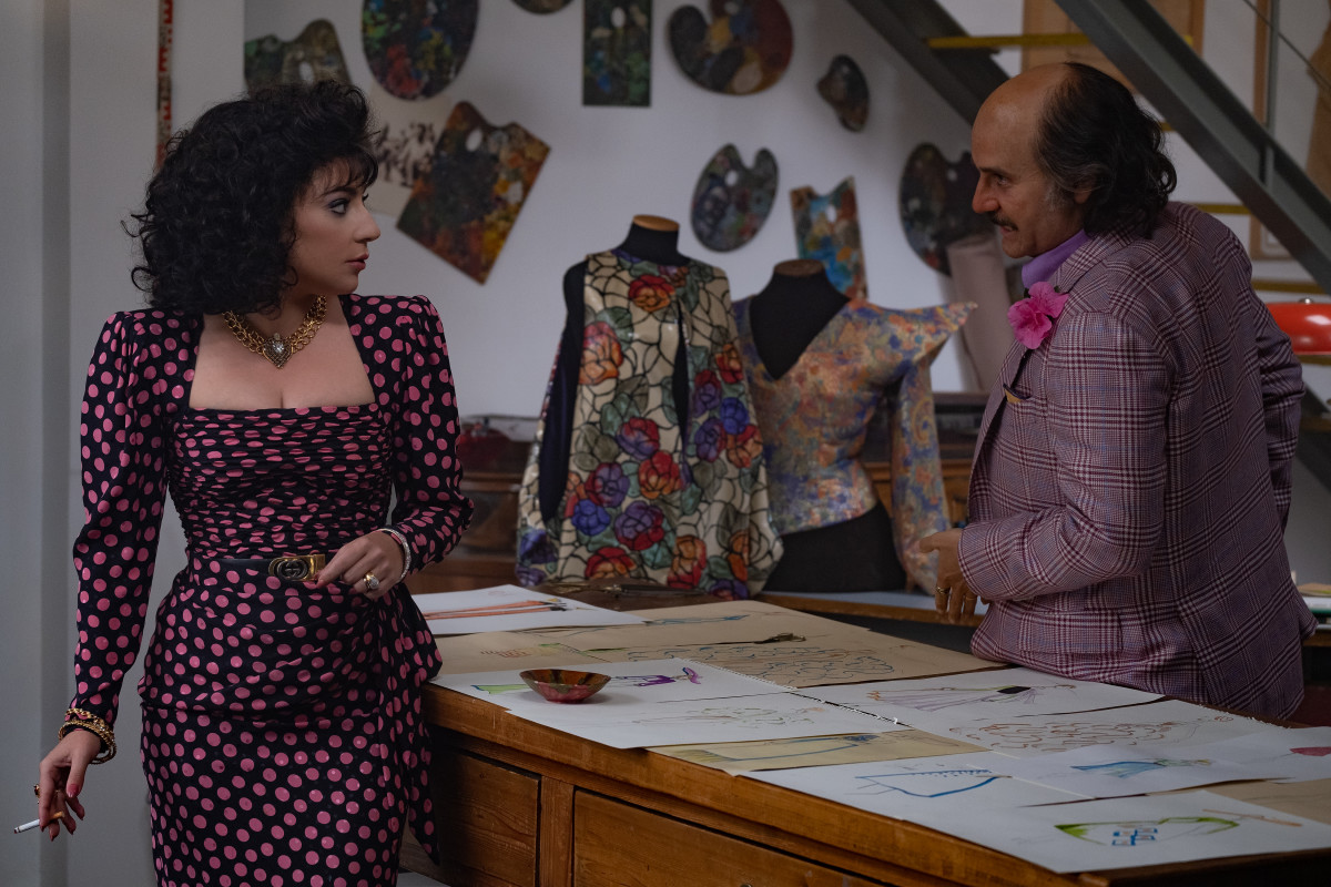 Patrizia coordinates with Paolo — and glimpses of his creative vision in the background.