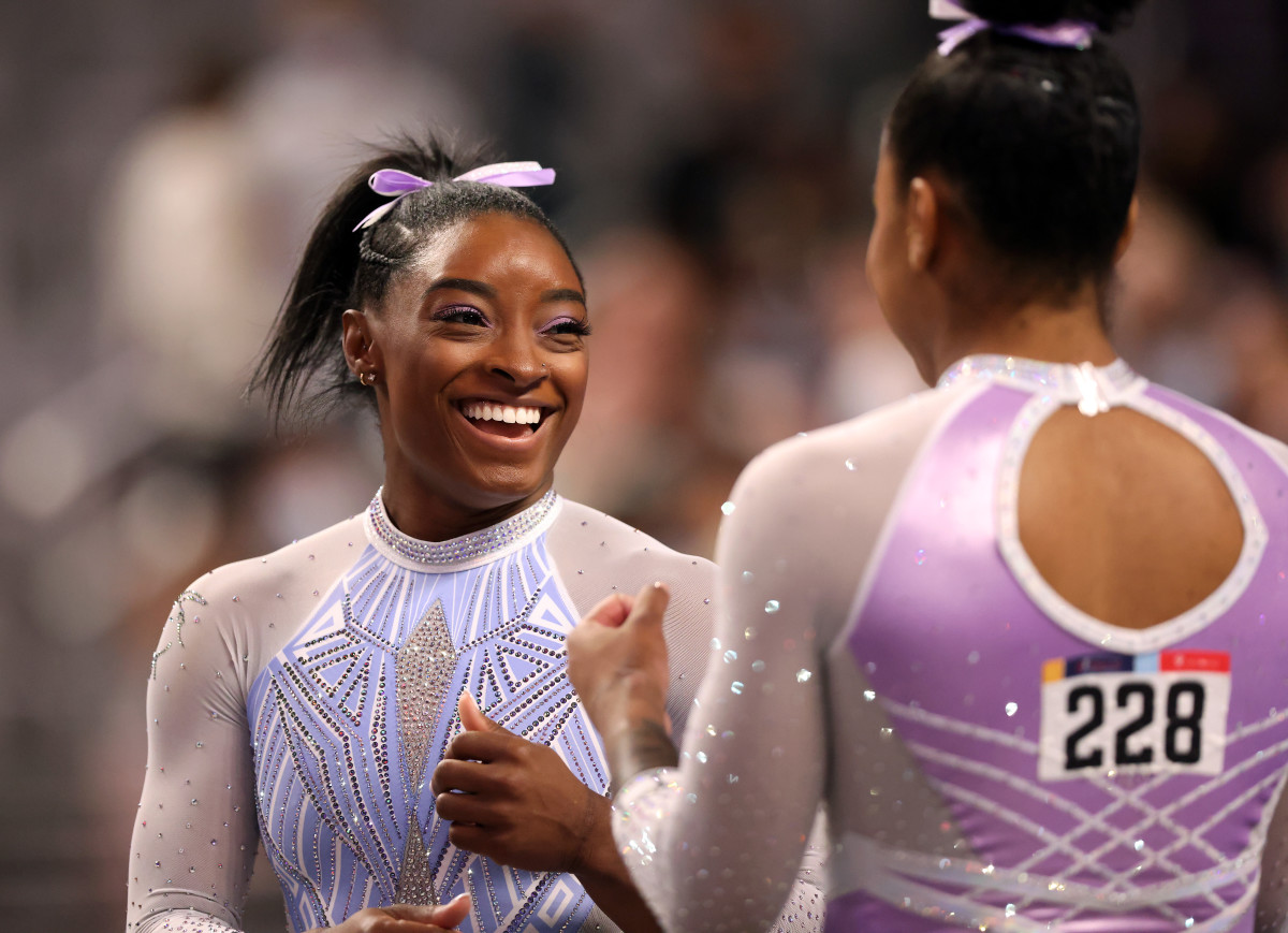 Simone Biles #227 and Jordan Chiles #228 joke while warming up for the beam during the Senior Women's competition of the 2021 U.S. Gymnastics Championships