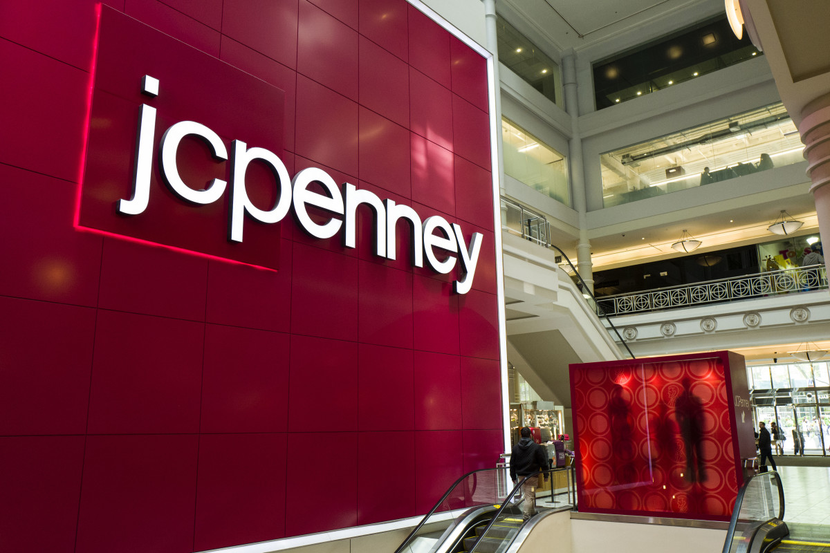 Signage is displayed at the entrance of a JC Penney department store inside the Manhattan Mall