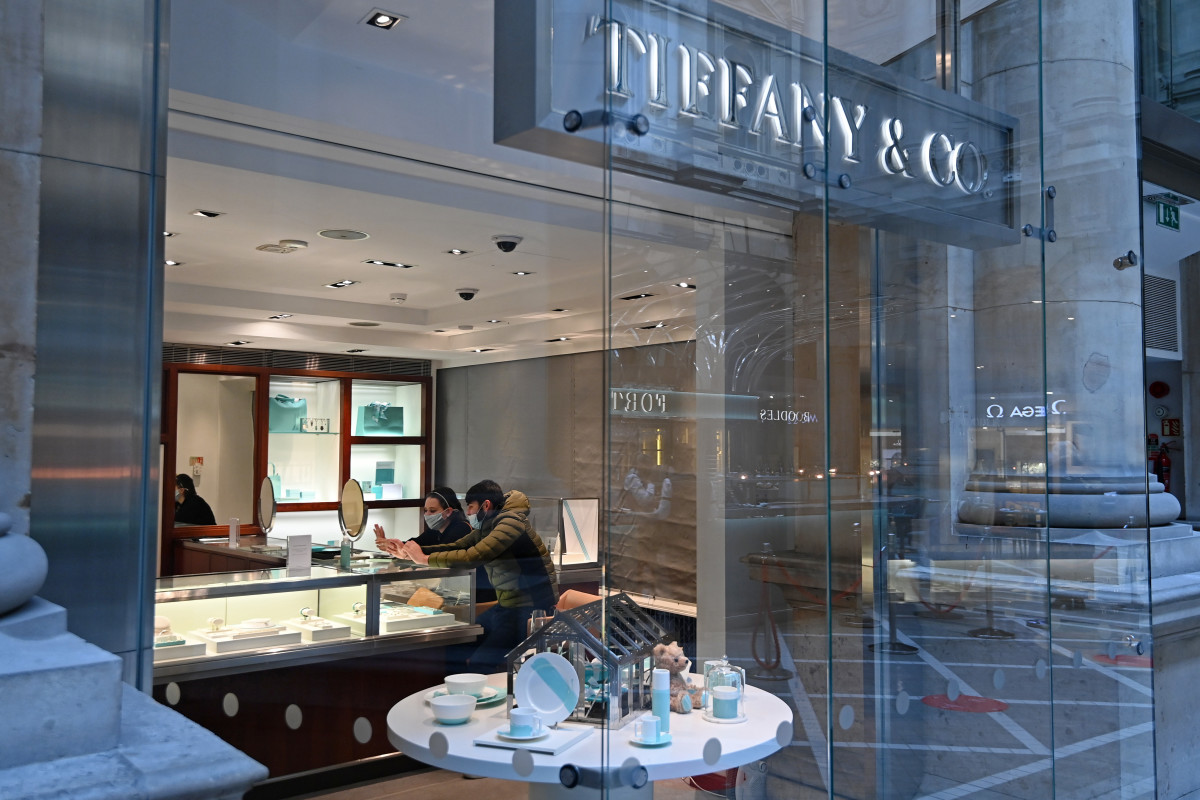 Customers wear a face covering as they shop in Tiffany & Co at The Royal Exchange on April 12, 2021 in London, England.