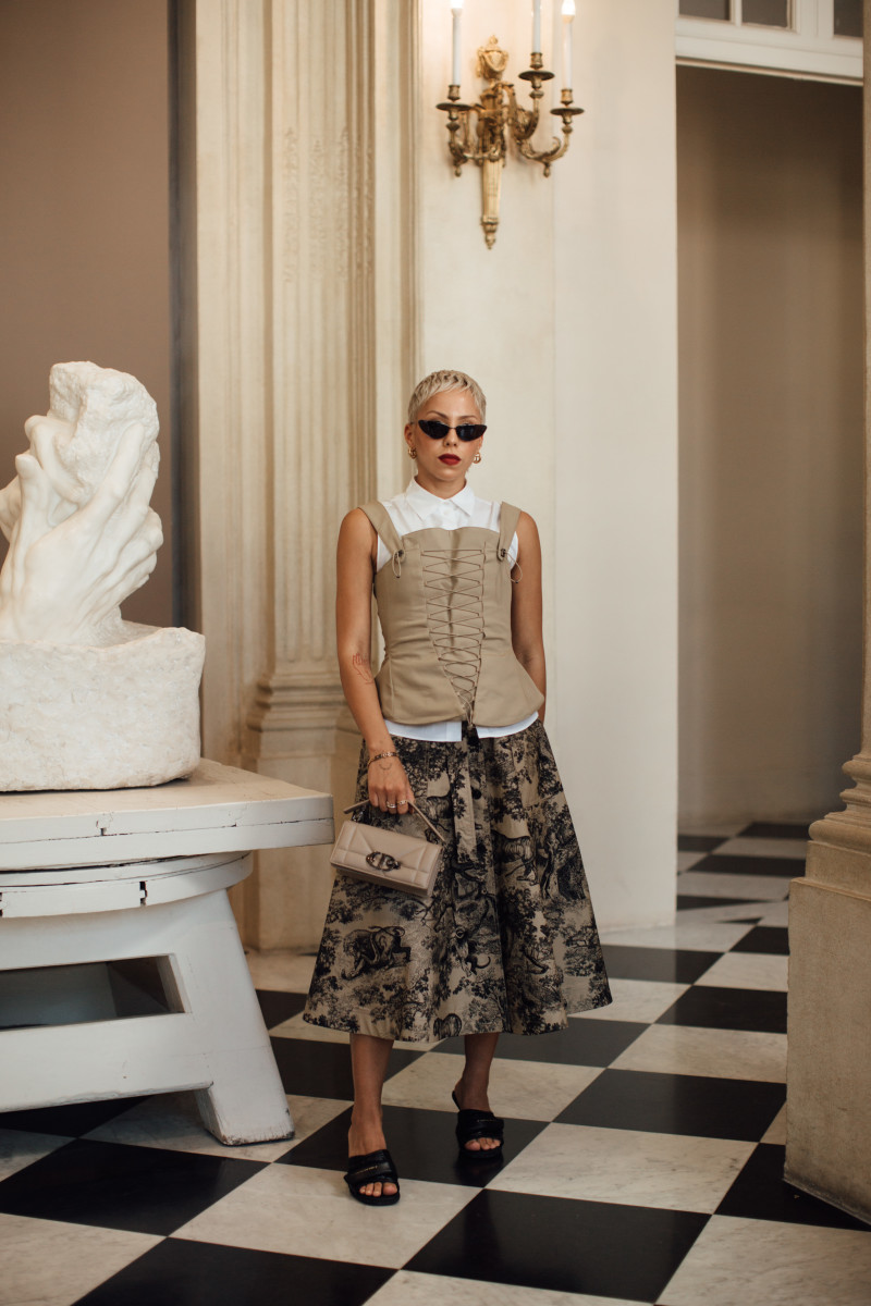 A corset-inspired top layered over a button-up and midi skirt during Haute Couture Fashion Week.