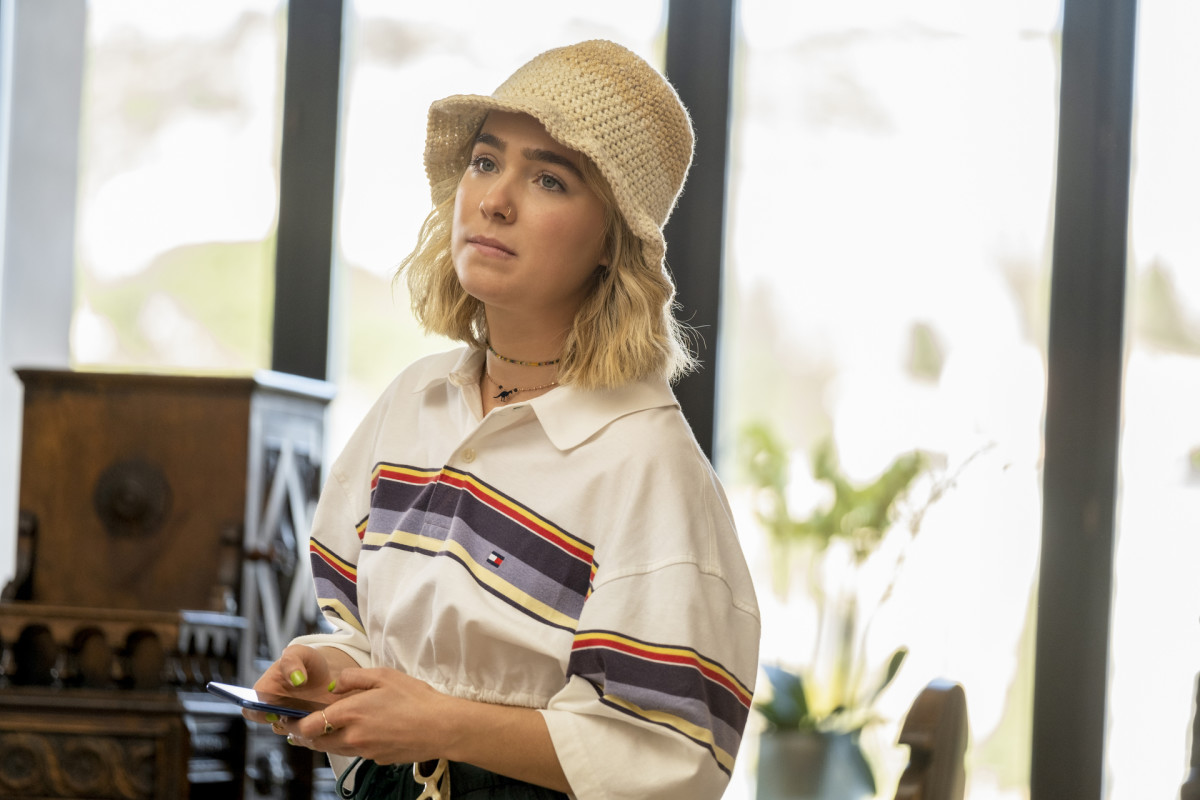 Portia (Haley Lu Richardson) enjoys breakfast in a repurposed Hilfiger cropped polo and crochet bucket hat knitted by Richardson herself.